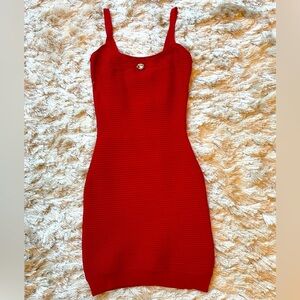 Red ribbed bodycon dress with jewel accent, perfect for a stylish night out.